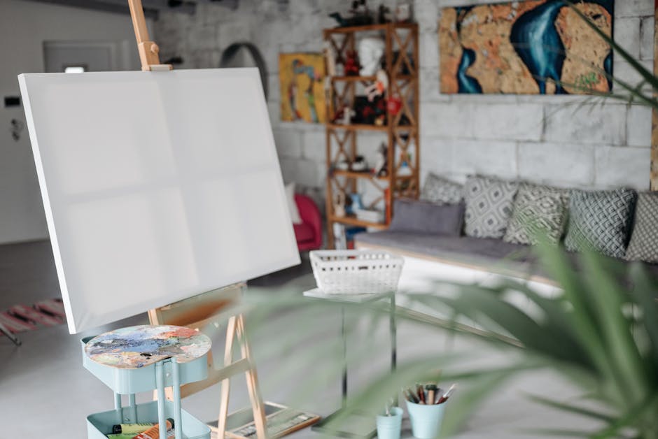 A cozy art studio with a blank canvas on an easel and colorful decor.